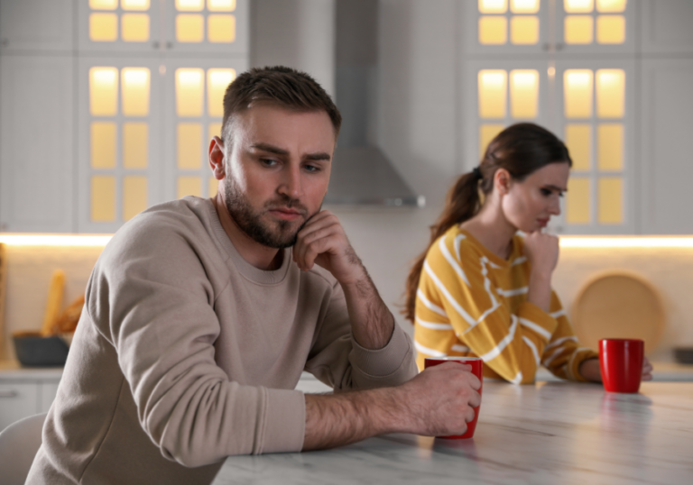 couple sitting not talking How a Man Feels When He Hurts a Woman: