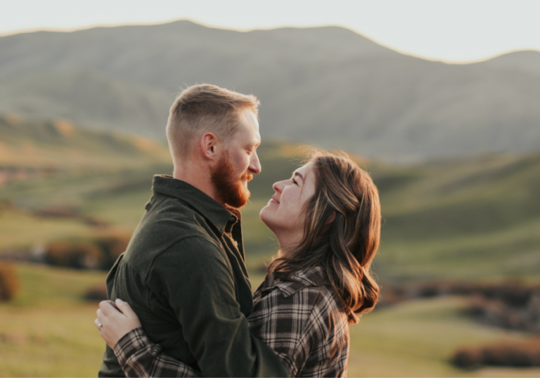 man and woman hugging in mountains Do Guys Like Being Called Handsome