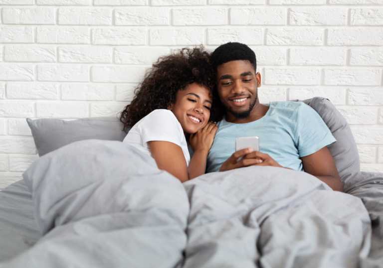 couple smiling talking in bed Bedtime Stories for Your Girlfriend