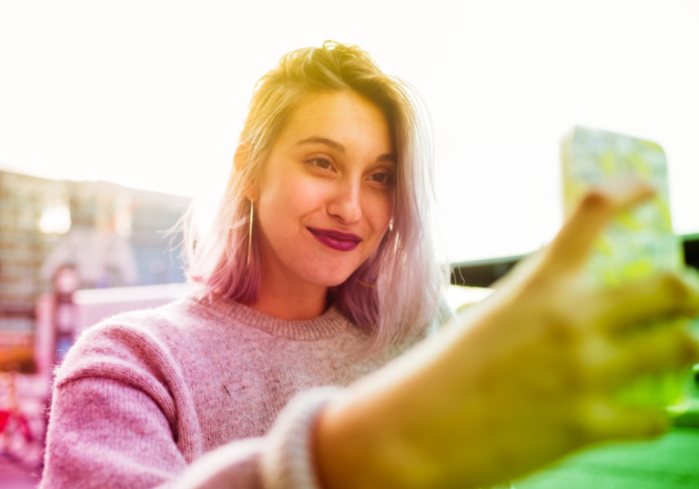 woman smiling looking at phone Snapchat Cheating