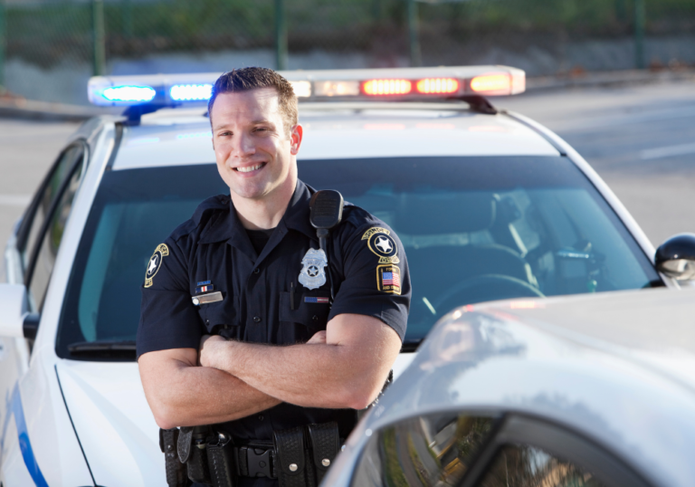 law enforcement officer smiling beside car dating a cop