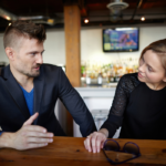 couple sitting at bar talking Couples Quiz Questions