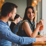 couple sitting at bar talking Keep a Conversation Going with a Girl