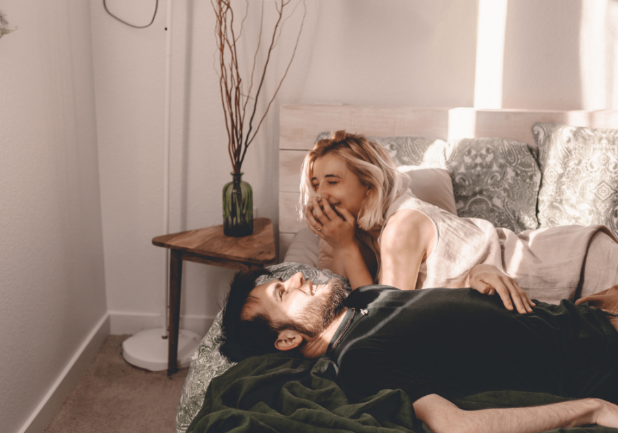 couple laying on sofa laughing Bedtime Stories for Your Girlfriend