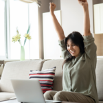 woman raising arms celebrating feeling defeated