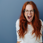 woman standing by wall screaming most dangerous zodiac sign when angry