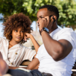 Couple sitting on bench man talking on phone Spouse Doesn't Want to Do Anything with You