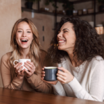 women laughing having coffee Best Favorite Things Questions