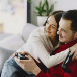 couple sitting on sofa hugging watching tv games to play with your girlfriend