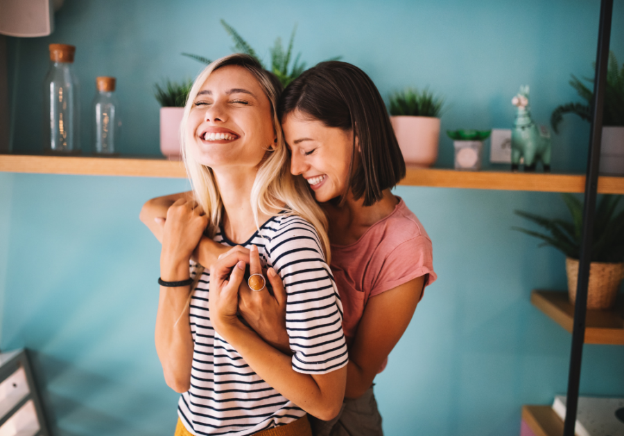 women hugging laughing Unconsciously Saying 