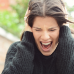 woman holding her head and screaming Why Do I Hate People