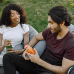 couple sitting outside talking Juicy Questions to Ask Your Boyfriend