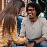 man laughing sitting with woman I Want a Girlfriend