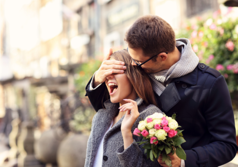 woman laughing at man covering her eyes Make Your Girlfriend Happy