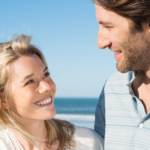 couple smiling at each other at beach Cute Things to Say to Your Crush