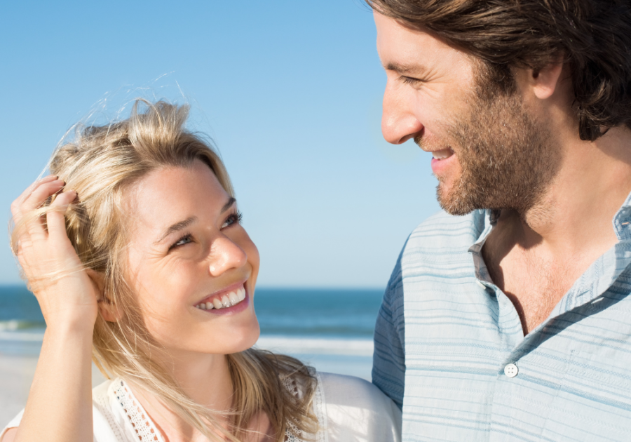 couple smiling at each other at beach Cute Things to Say to Your Crush