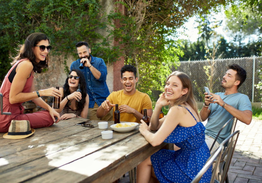 group sitting at outdoor table Put a Finger Down Questions