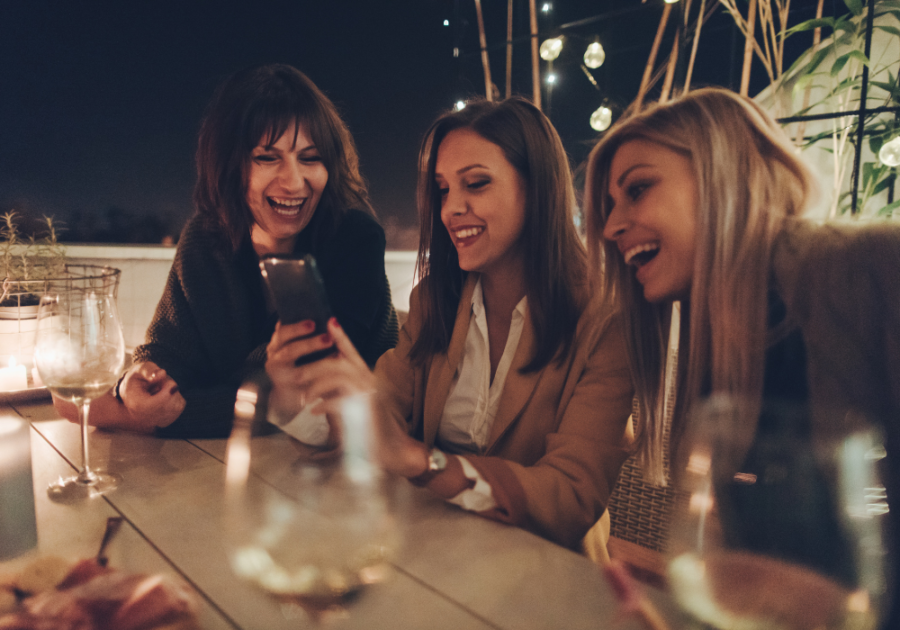 women smiling sitting a table girls night questions