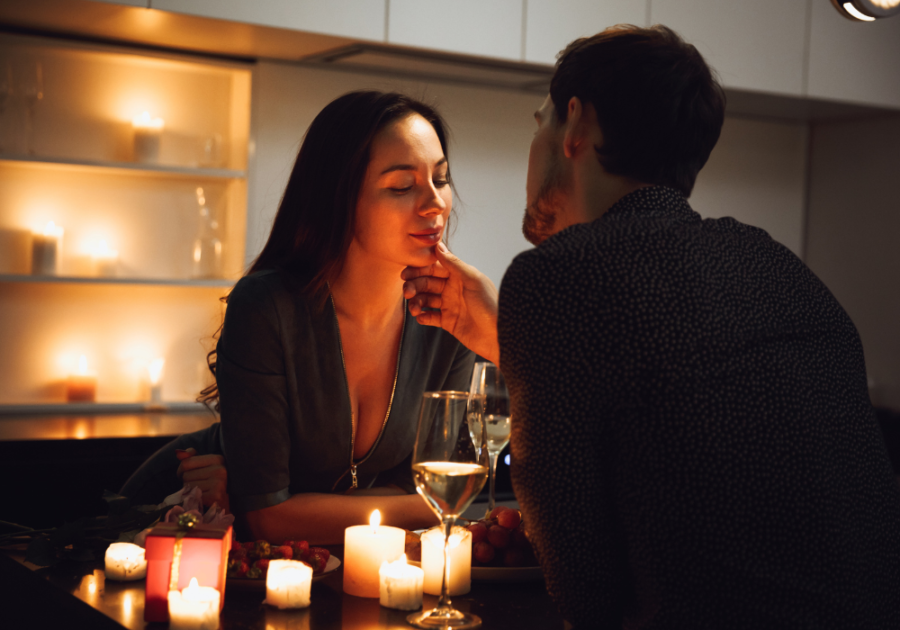 couple sitting at candlelight dinner Make Your Girlfriend Happy