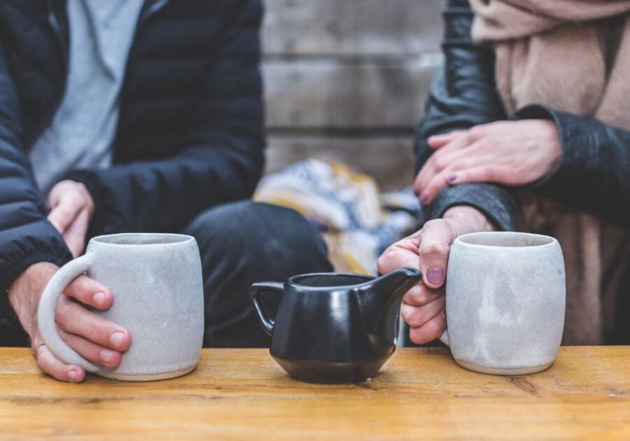 couple sitting and having coffee  Signs a Sagittarius Man Has Feelings for You