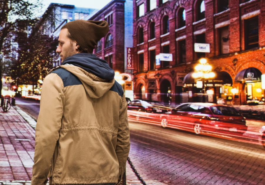 man walking in city at dusk alone on a Friday night