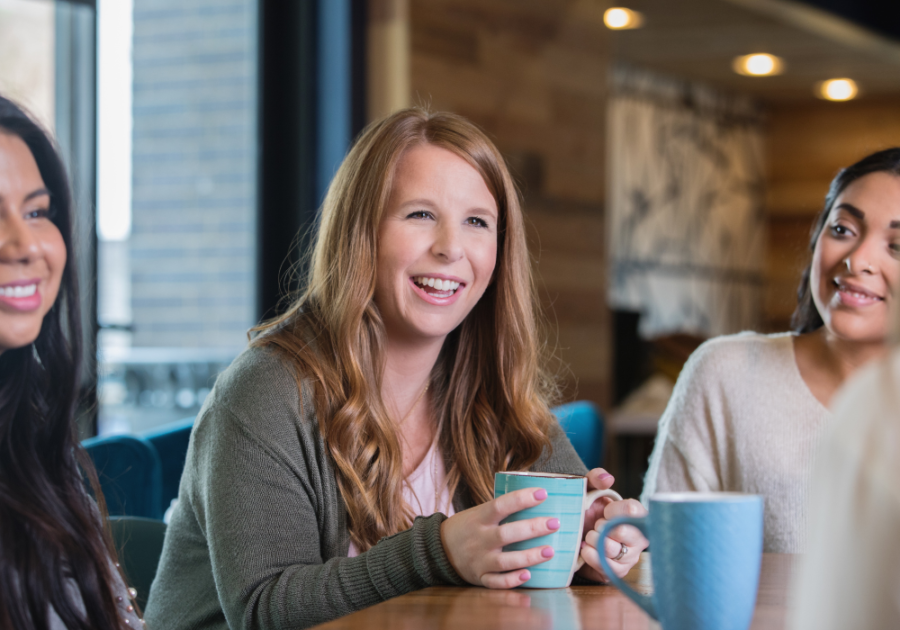 group sitting at table having coffee How to Make Friends in Your 30s