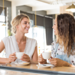 女人坐在桌子having coffee How to Make Friends in Your 30s