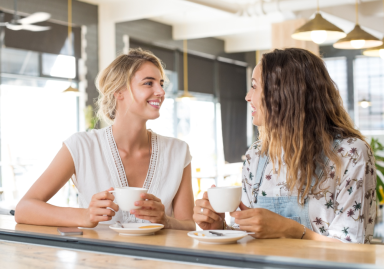 women sitting at table having coffee How to Make Friends in Your 30s