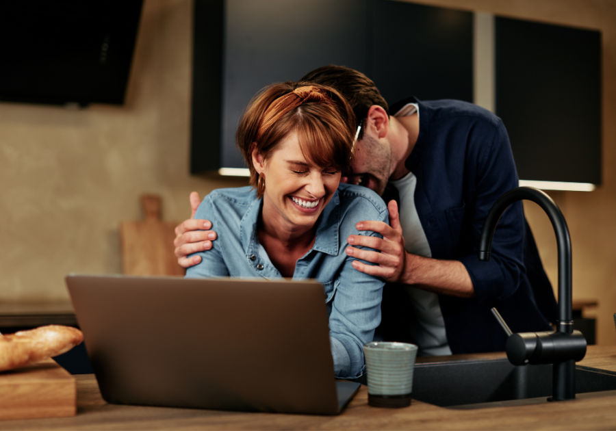 couple laughing looking at computer Put a Finger Down Questions