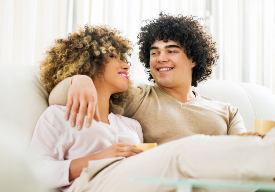 couple sitting up in bed Does Body Count Matter