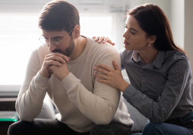 woman sitting by man consoling him a When a Guy Tells You Personal Things About Himself