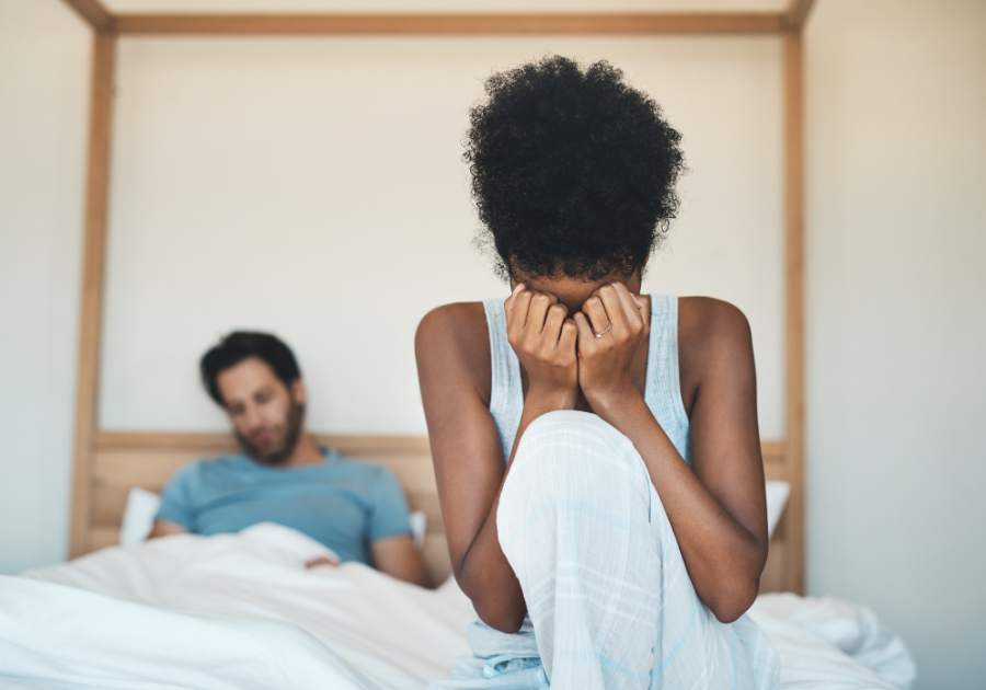 woman sitting on end of bed crying girlfriend wets the bed