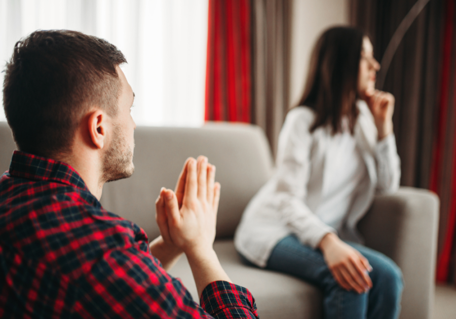 man appealing to woman sitting on sofa how to apologize Apologize for Cheating