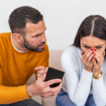 man angry showing woman phone Do Cheaters Ever Realize What They’ve Lost