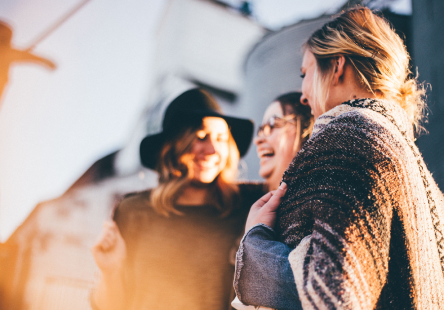 group of women outdoors laughing scary games to play with friends