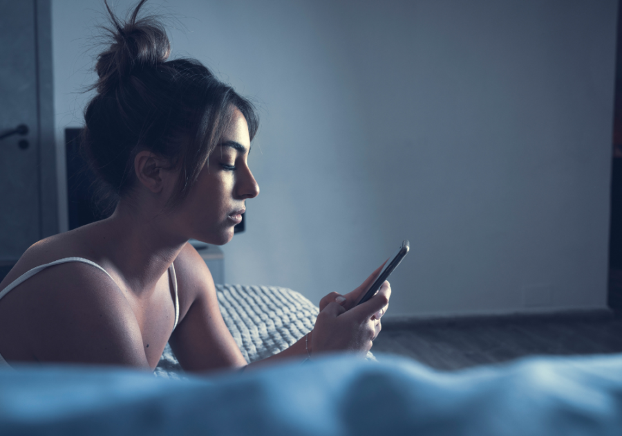 woman looking at phone is sexting cheating