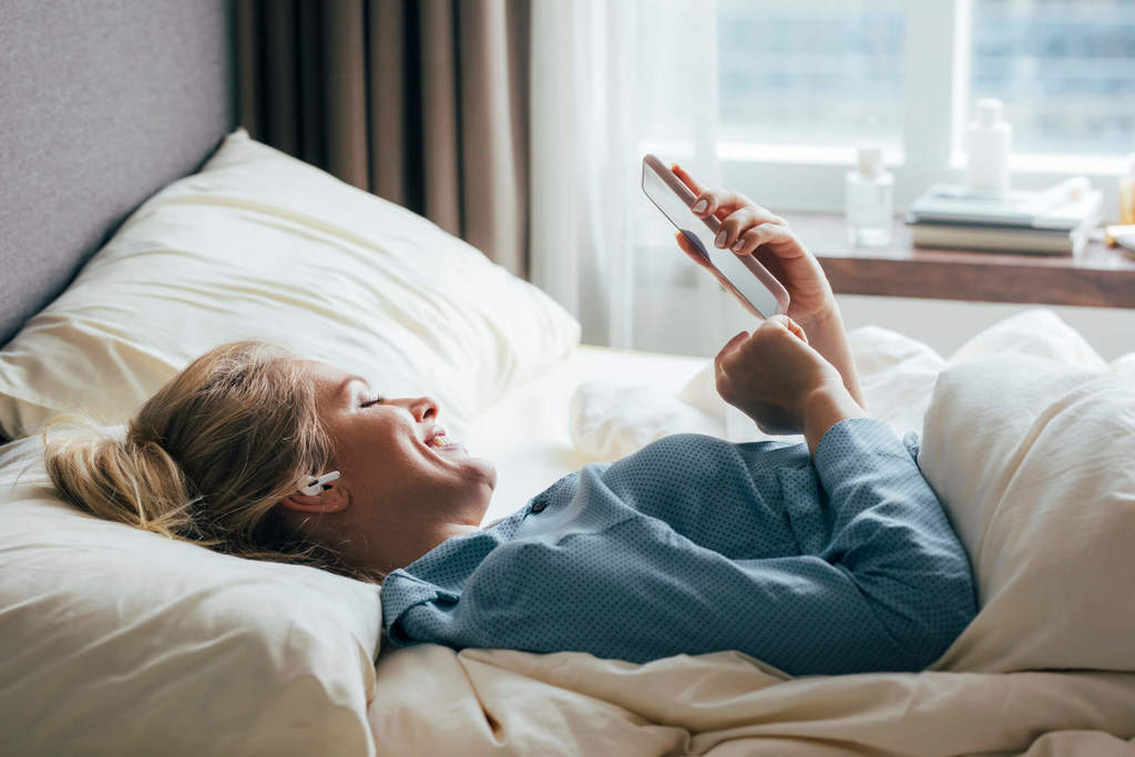 woman texting in bed sweet texts for him