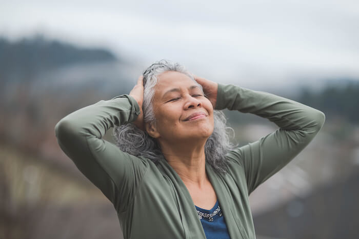 Woman relaxing outside gratitude vs thankful