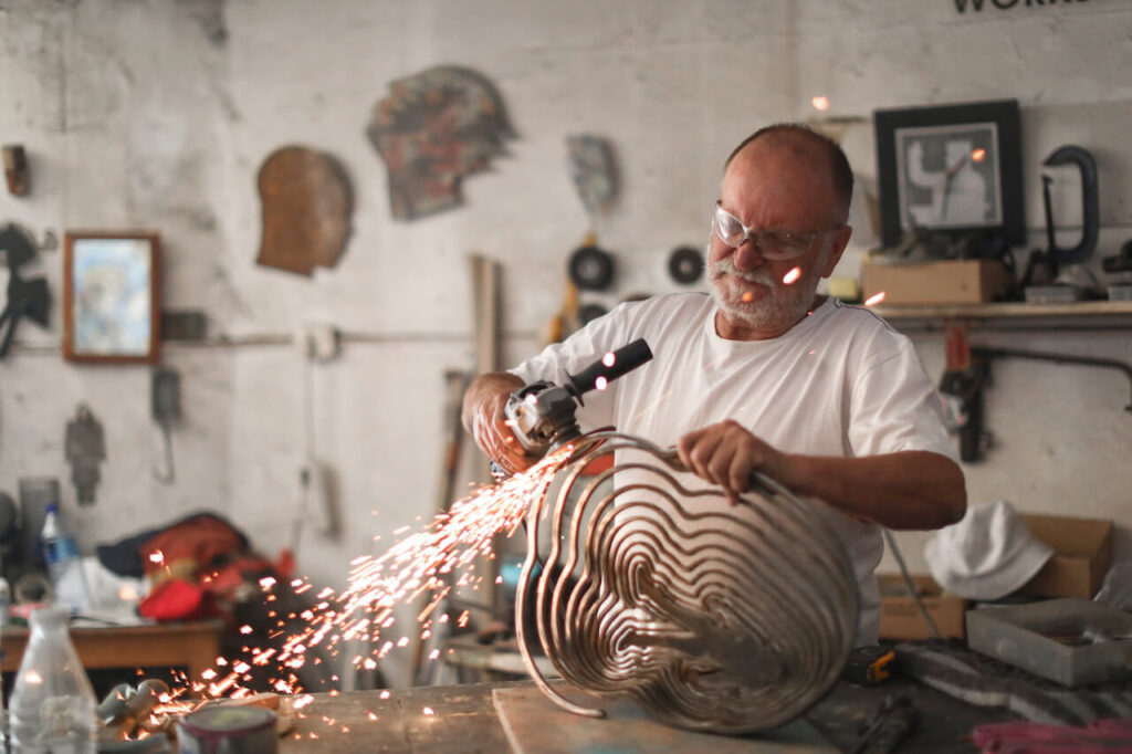 old man doing welding low-stress jobs after retirement