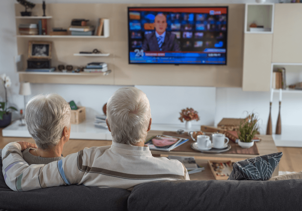senior couple watching tv television for seniors