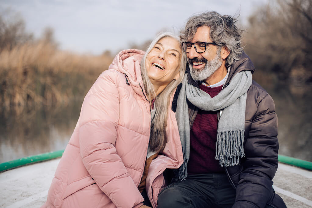 senior couple having fun sailing ways to tell if a man over 50 likes you