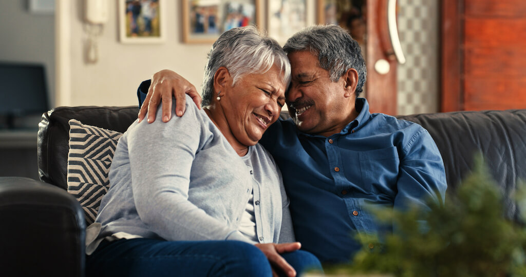 mature couple sweetly hugging ways to tell if a man over 50 likes you