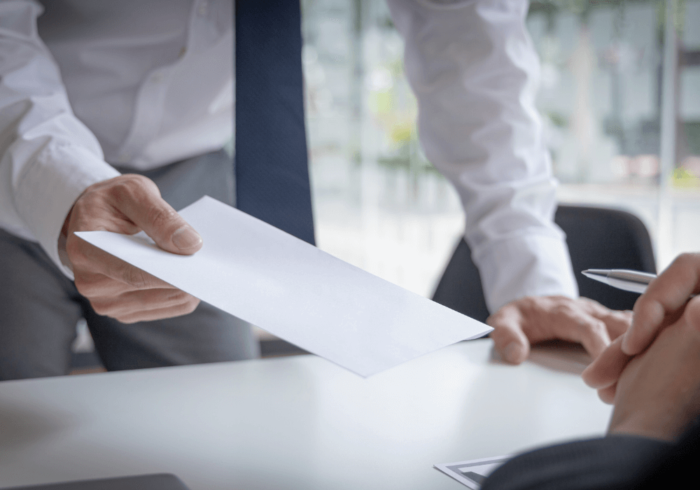 person holding paper what is the difference between resignation and early retirement