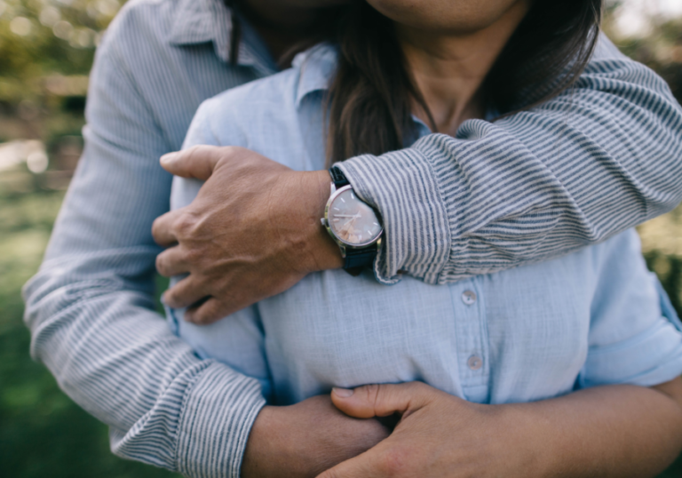 man hugging woman from behind qualities of a good husband
