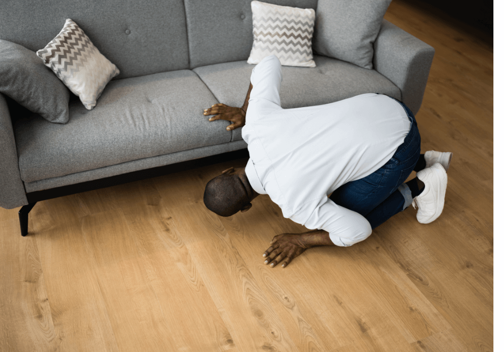 man looking under sofa How to Find Things You Lost At Home