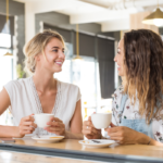 women sitting at table having coffee How to Make Friends in Your 30s